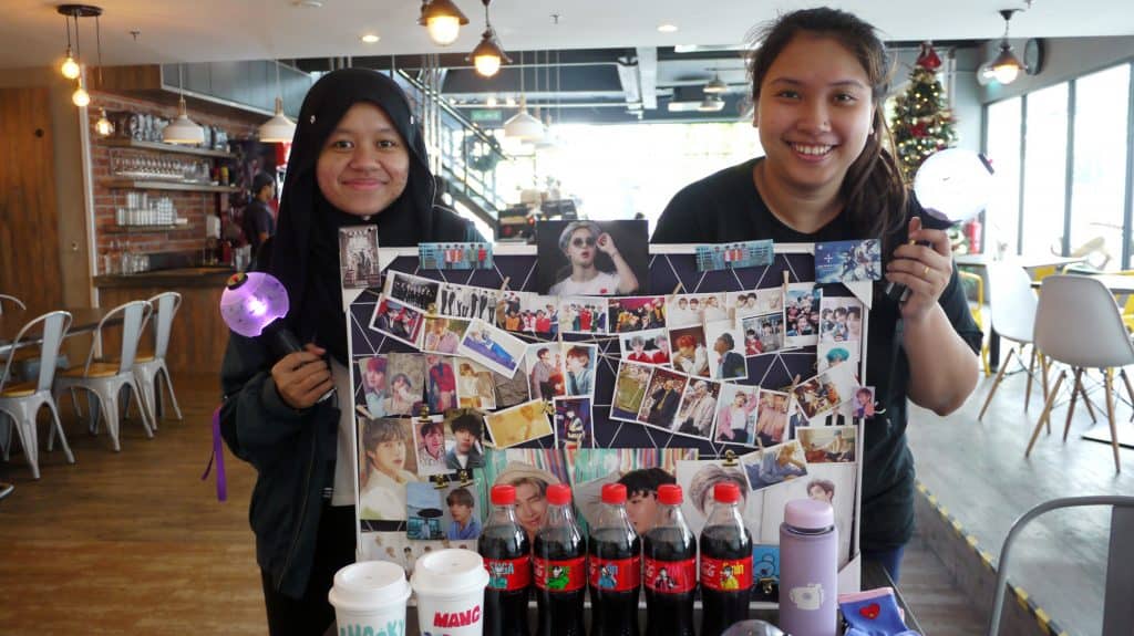 Atiqah (left) and Shashfiny with their BTS merchandises